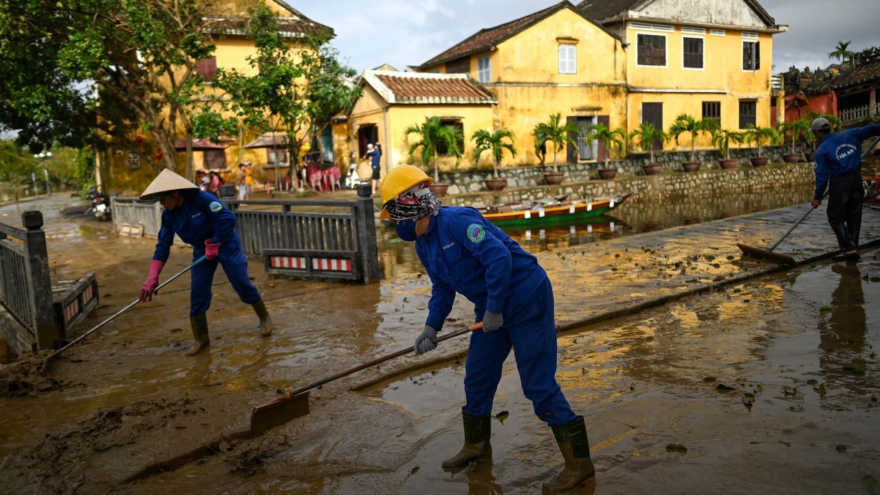 Municipal workers clean up the streets after waters receded in the old city of Hoi An on October 30, 2020, in the aftermath of Typhoon Molave.