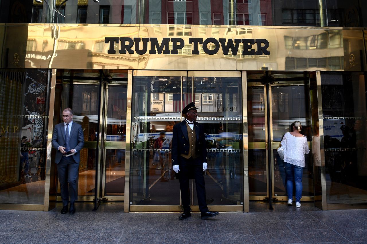A guard stands at the entrance of New York's Trump Tower on Tuesday, the second day of the trial.