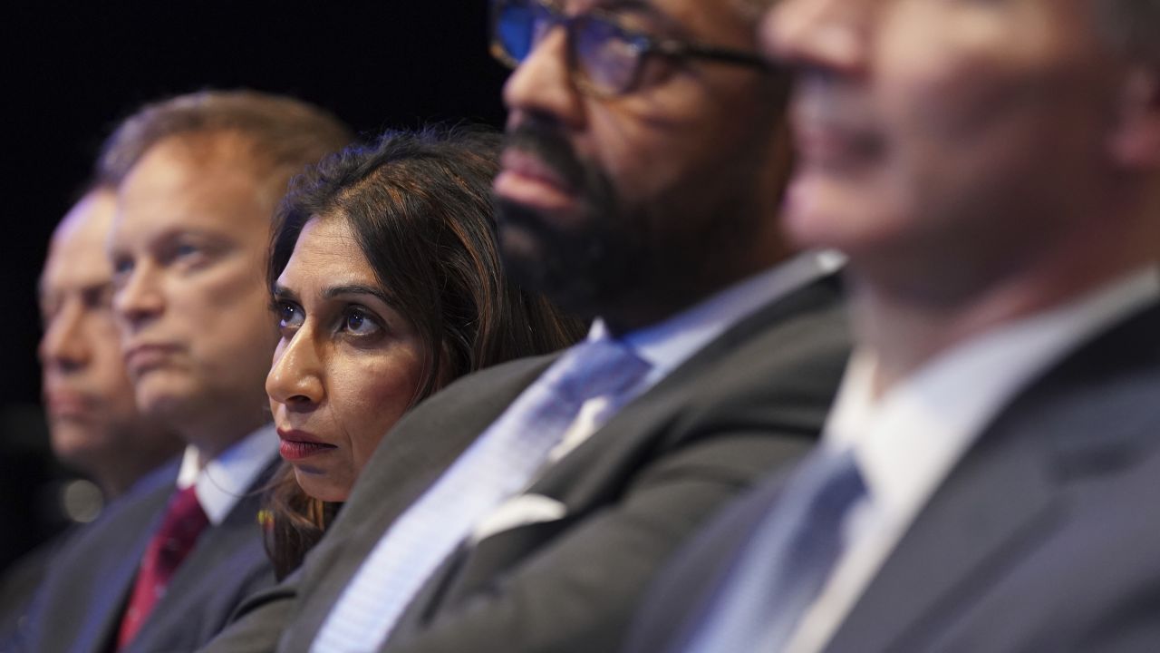 (Left to right) Defense Secretary Grant Shapps, Home Secretary Suella Braverman and Foreign Secretary James Cleverly listen to Sunak as he delivers his keynote speech on October 4, 2023.