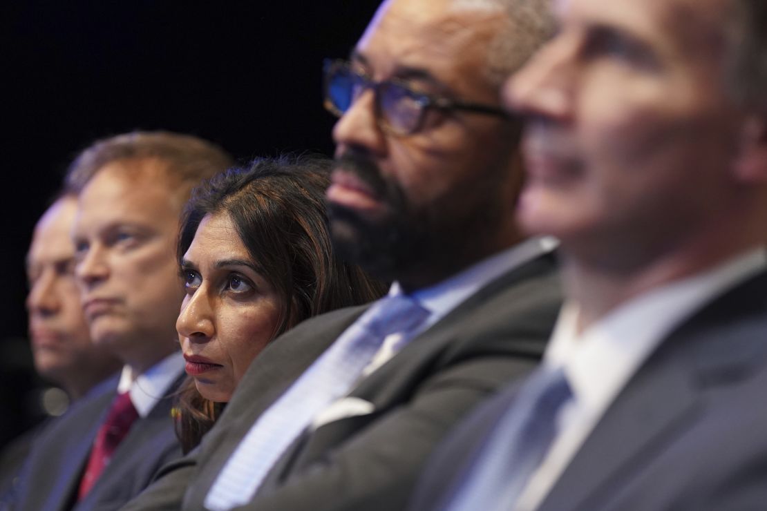 (Left to right) Defense Secretary Grant Shapps, Home Secretary Suella Braverman and Foreign Secretary James Cleverly listen to Sunak as he delivers his keynote speech on October 4, 2023.