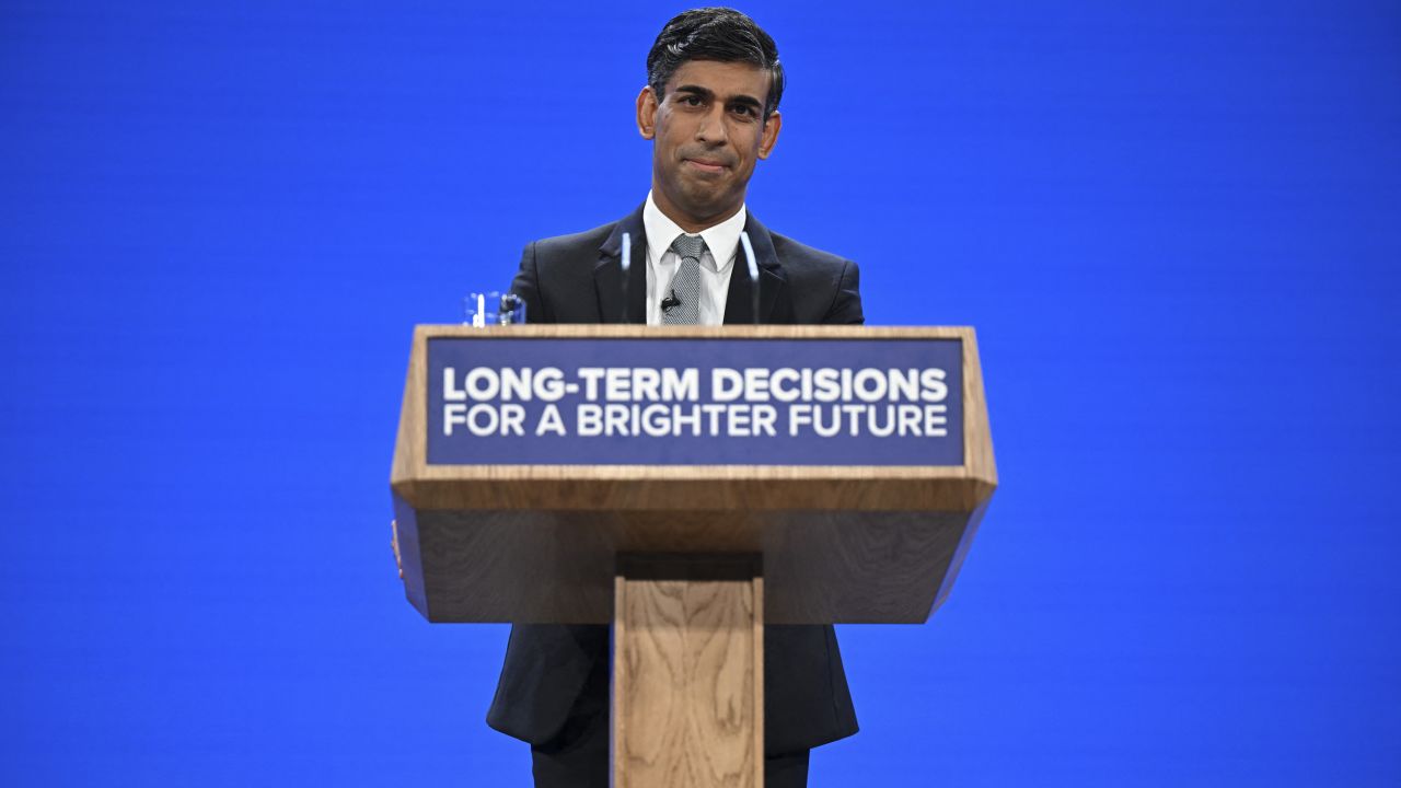 Britain's Prime Minister Rishi Sunak addresses delegates at the annual Conservative Party Conference in Manchester, northern England, on October 4, 2023.
