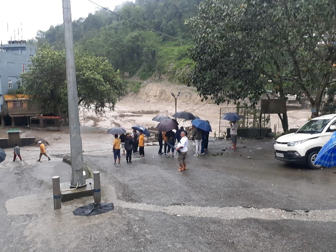 People inspect the damage from flash flooding in Sikkim, India on Wednesday, Oct. 4, 2023.