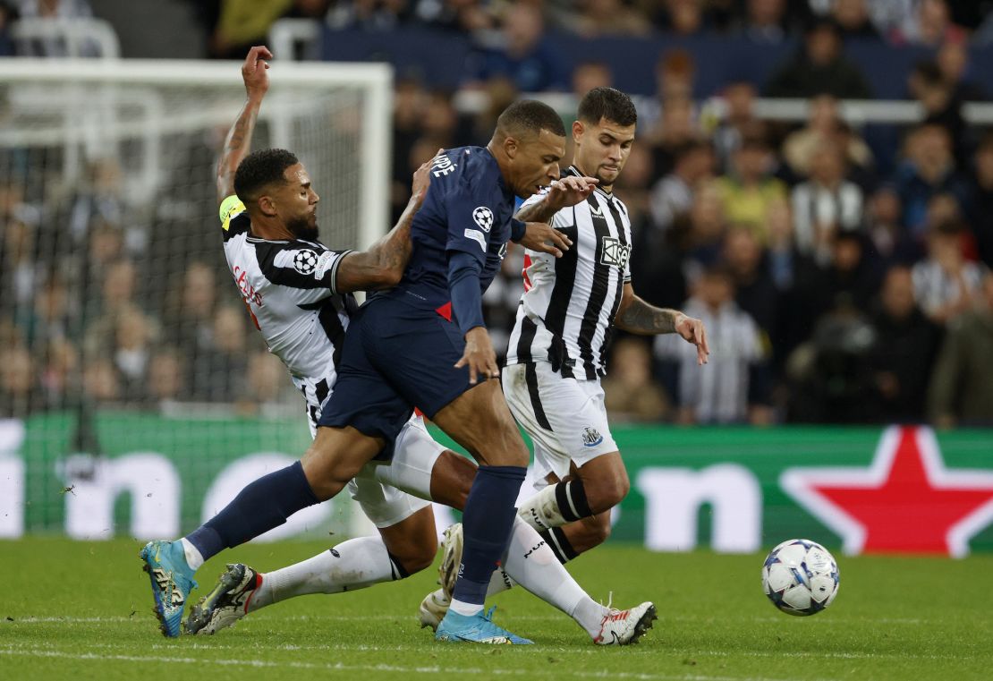 NEWCASTLE UPON TYNE, ENGLAND - OCTOBER 4: Jamaal Lascelles and Bruno Guimaraes of Newcastle United and Kylian Mbappe challenge during the UEFA Champions League match between Newcastle United and Paris Saint-Germain at St. James' Park on October 4, 2023 in Newcastle Upon Tyne, England. (Photo by Richard Sellers/Sportsphoto/Allstar via Getty Images)