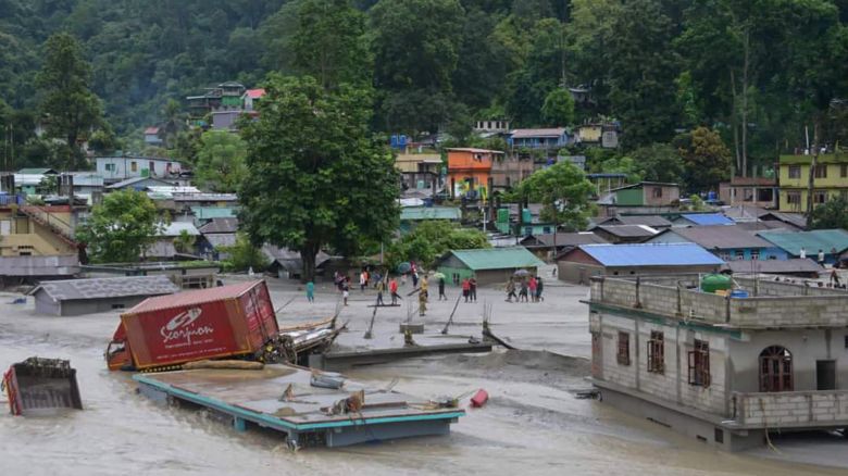 A vehicle that got washed away lies atop a submerged building after flash floods triggered by a sudden heavy rainfall swamped the Rangpo town in Sikkim, India, Thursday, Oct.5. 2023. The flooding took place along the Teesta River in the Lachen Valley of the north-eastern state, and was worsened when parts of a dam were washed away. (AP Photo/Prakash Adhikari)