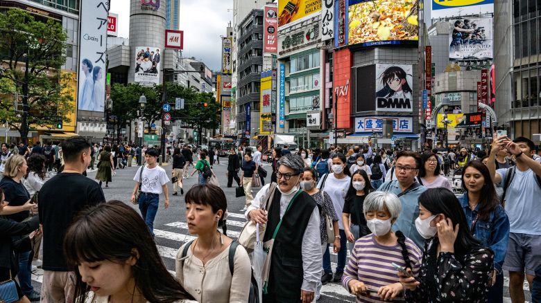 People walk across "Shibuya Crossing" in the Shibuya district of Tokyo on June 14, 2023. (Photo by Philip FONG / AFP) (Photo by PHILIP FONG/AFP via Getty Images)