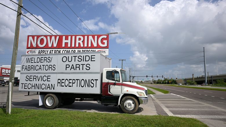 A Now Hiring sign advertising job openings is viewed outside a Truck dealership, Monday, October 2, 2023, in Tampa, Fla. 