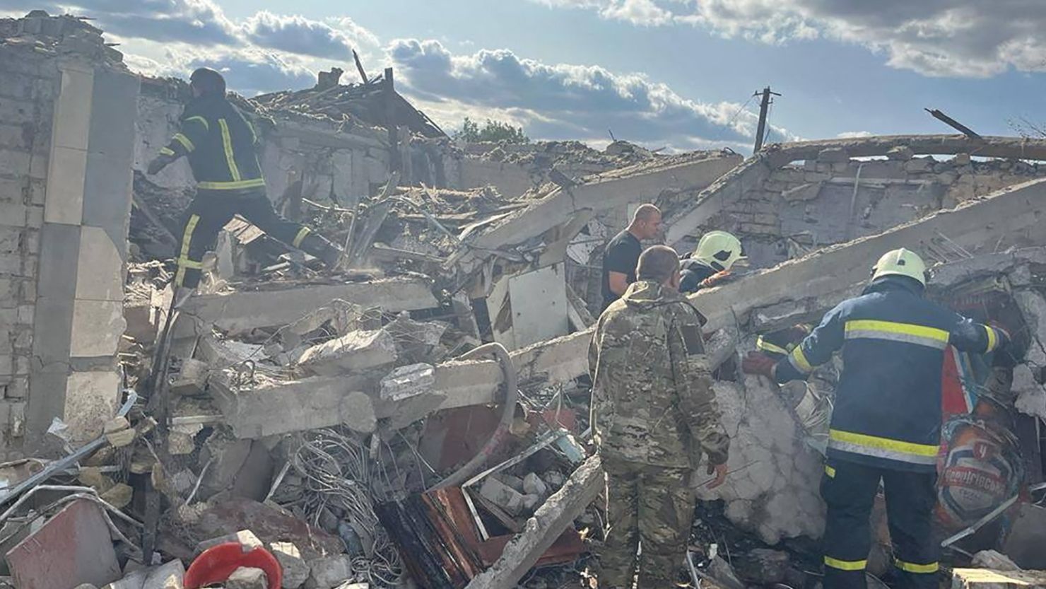 Rescue workers can be seen at the site of a Russian military strike in the village of Hroza, in eastern Ukraine, on October 5.