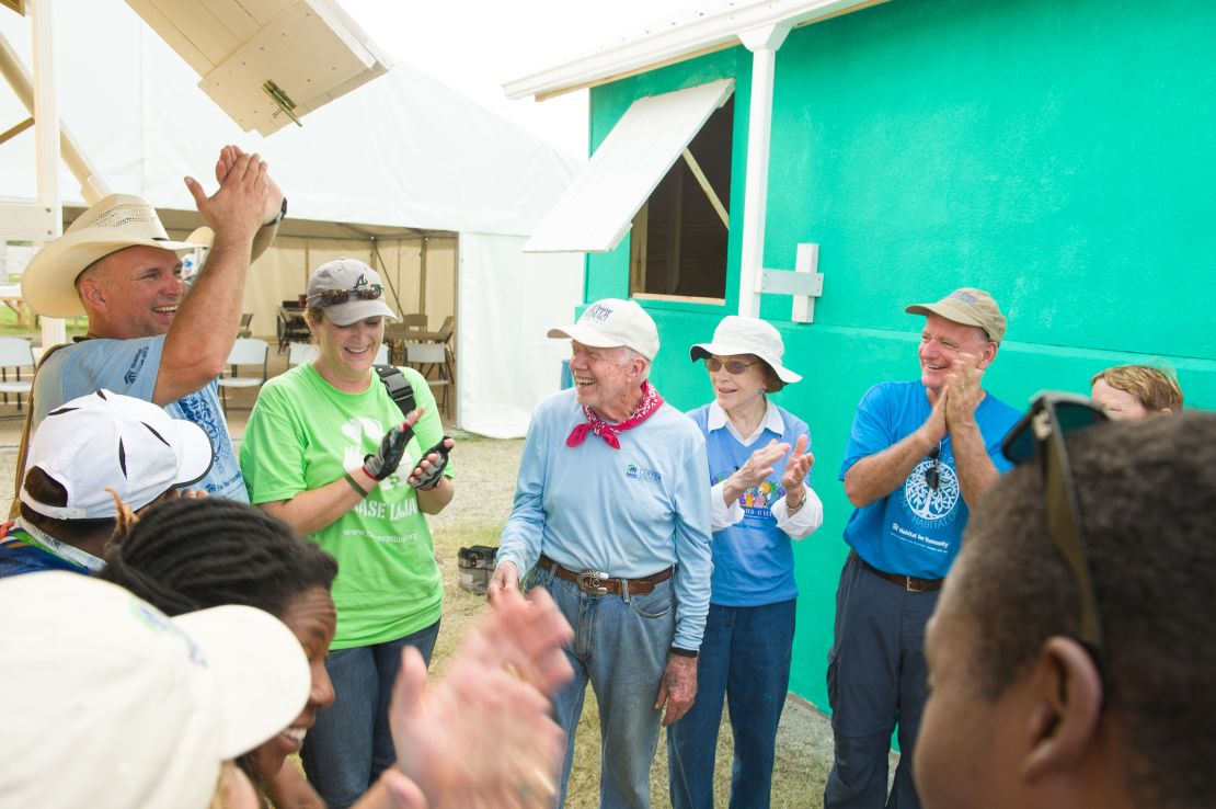 The Carters along with Garth Brooks and Trisha Yearwood dedicate the houses they helped build in Haiti in 2012.