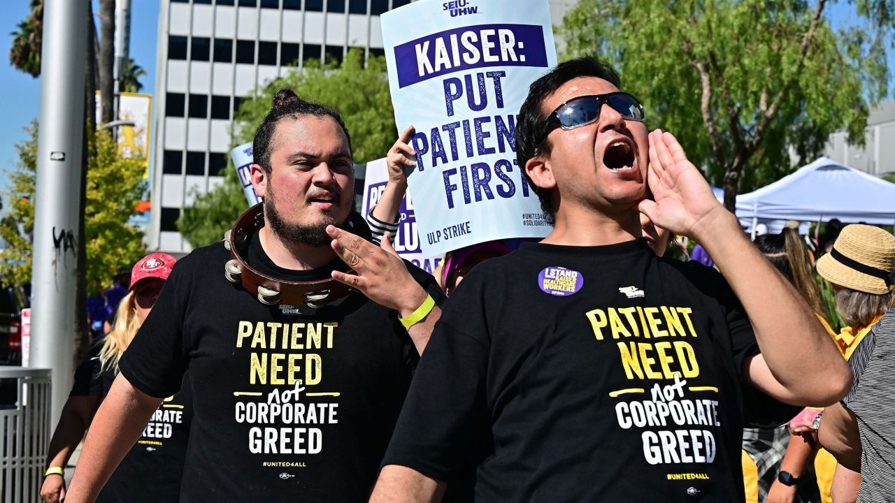 Kaiser Permanente health care employees, joind by Union members representing workers, walk the picket line in Los Angeles during the second day of their strike on October 5, 2023. More than 75,000 employees at Kaiser Permanente began one of the largest healthcare worker strikes in recent US history on October 4 after failing to resolve a dispute over staffing levels. (Photo by Frederic J. BROWN / AFP) (Photo by FREDERIC J. BROWN/AFP via Getty Images)