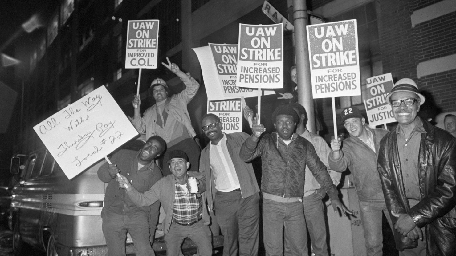 General Motors workers wave picket signs outside a Detroit, Michigan GM plant after the United Auto Workers struck giant General Motors at midnight on September 14, 1970.