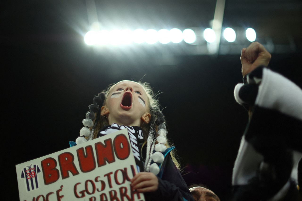 A young Newcastle United fan shows support for midfielder Bruno Guimarães before a Champions League match in Newcastle upon Tyne, England, on Wednesday, October 4.