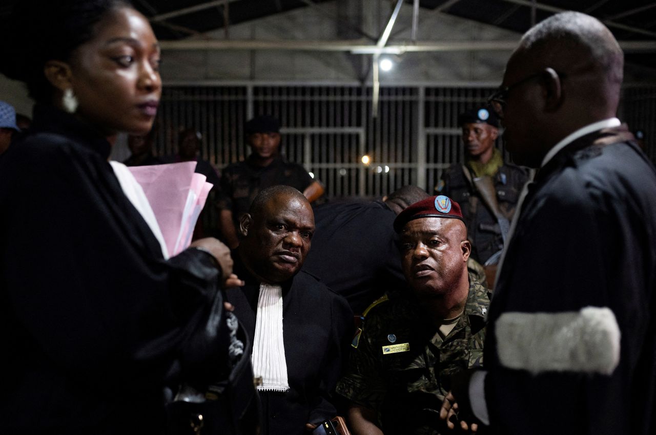 Congolese Army Col. Mike Mikombe sits with his lawyer Serge Lukanga after being sentenced to death in Goma, Democratic Republic of Congo, on Monday, October 2. Mikombe was convicted of murder and other crimes related to <a href="https://www.cnn.com/2023/09/01/africa/anti-un-protests-drc-peacekeeping-intl/index.html" target="_blank">the killing of dozens of civilians during an anti-UN demonstration in August</a>.