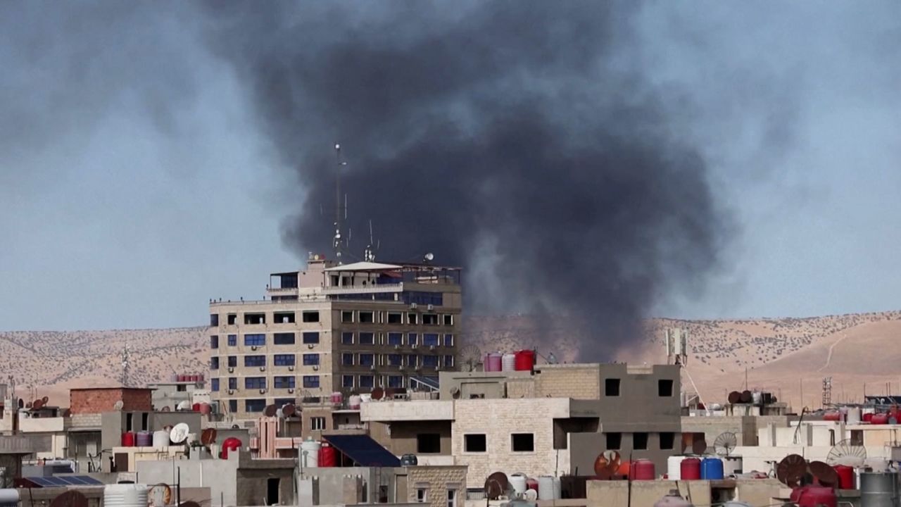 Smoke rises over buildings from a reported drone strike in Qamishli, Syria.