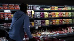 A shopper near fresh fruit at a H Mart grocery store in Fairfax, Virginia, US, on Thursday, April 6, 2023. 