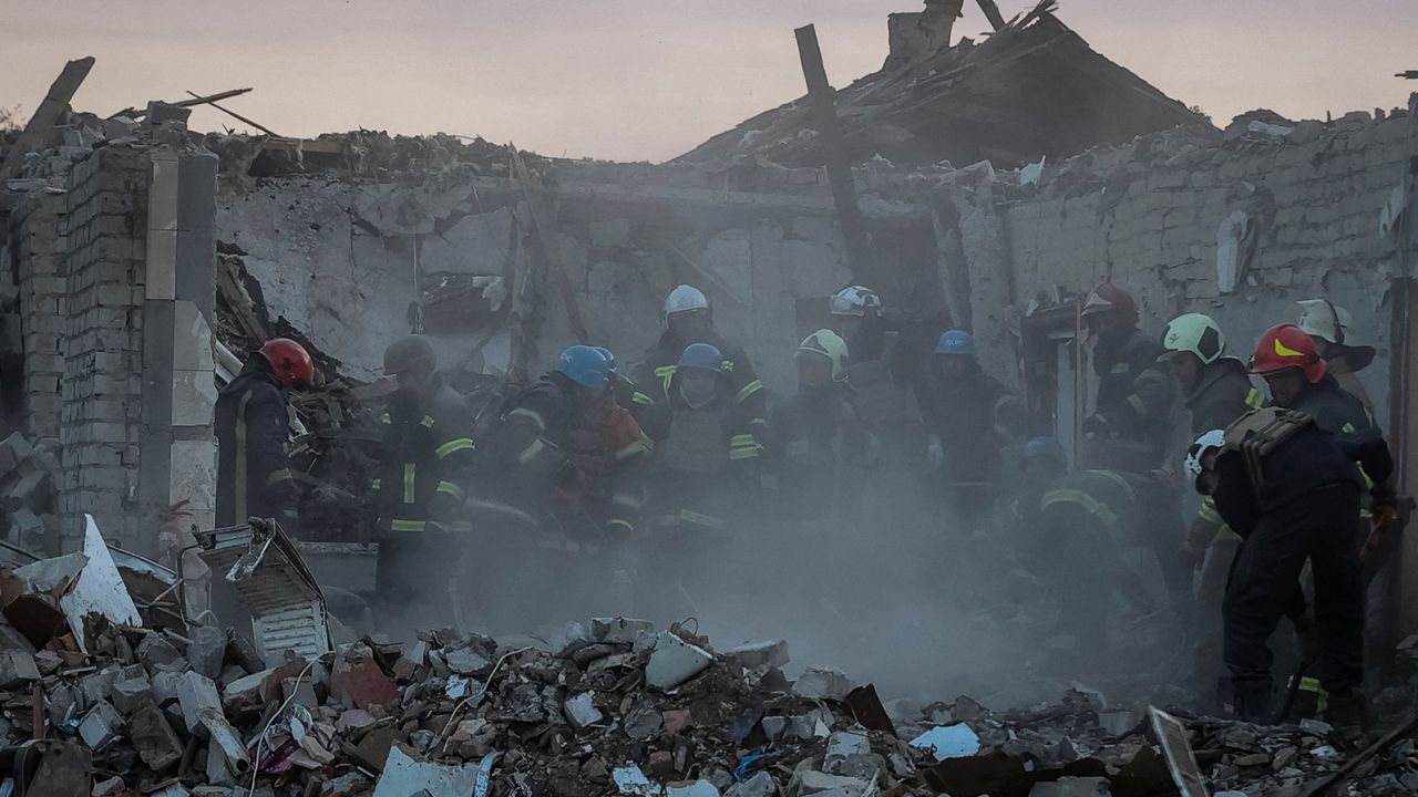 Rescuers work at the site of a Russian military strike in the village of Hroza, in the Kharkiv region of Ukraine on October 5.