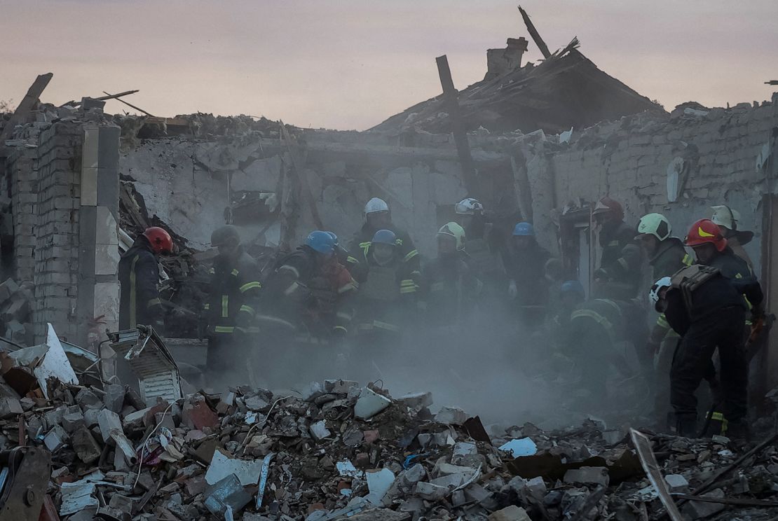 Rescuers work at the site of a Russian military strike in Hroza village on October 5.