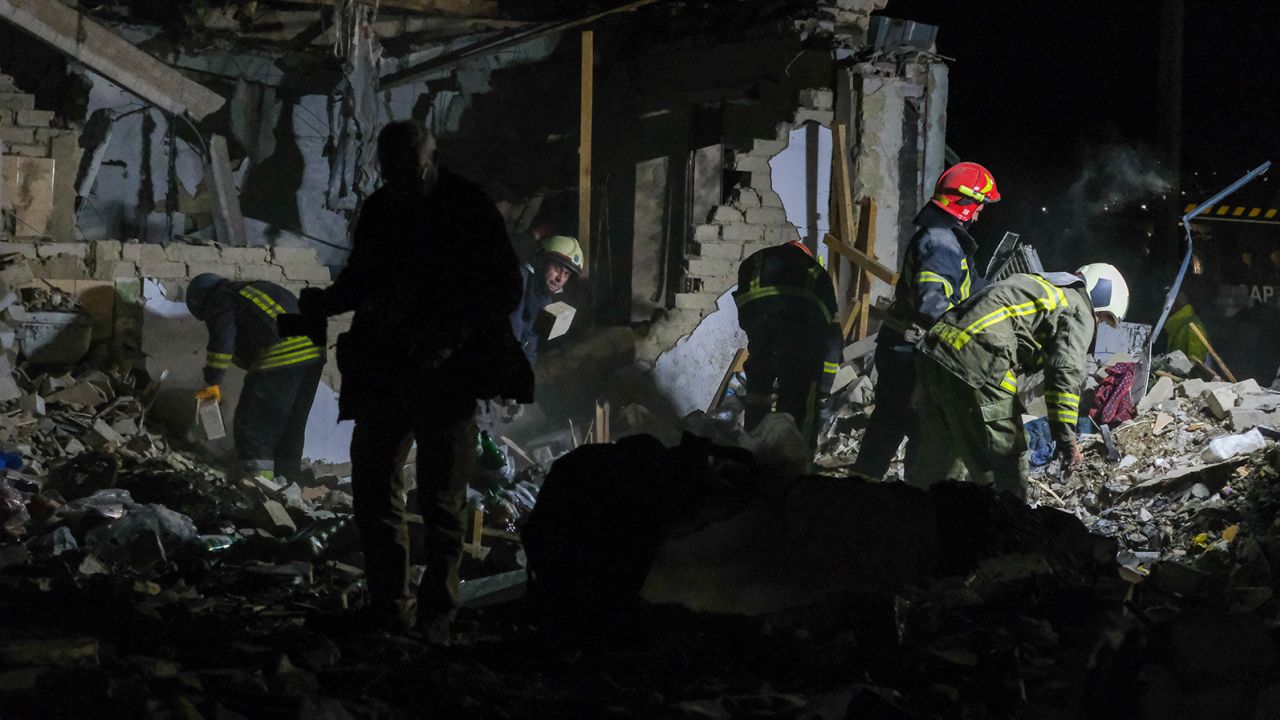 Members of Ukraine's emergency services at the scene of a Russian missile strike in the village of Hroza, Kharkiv region, eastern Ukraine on October 5.