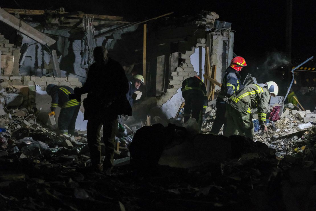 Members of Ukraine's emergency services at the scene of a Russian missile strike in the village of Hroza, Kharkiv region, eastern Ukraine on October 5.
