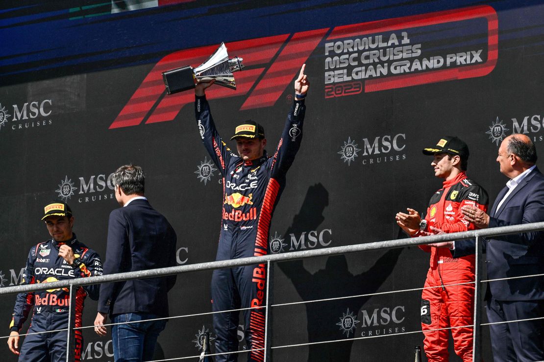 Winner Red Bull Racing's Dutch driver Max Verstappen (C), second-placed Red Bull Racing's Mexican driver Sergio Perez (L) and third-placed Ferrari's Monegasque driver Charles Leclerc  (2nd R) celebrate  on the podium  as  Belgium's Prime Minister Alexander De Croo (2nd L) congratulates them after the Formula One Belgian Grand Prix at the Spa-Francorchamps Circuit in Spa on July 30, 2023. (Photo by JOHN THYS / AFP) (Photo by JOHN THYS/AFP via Getty Images)