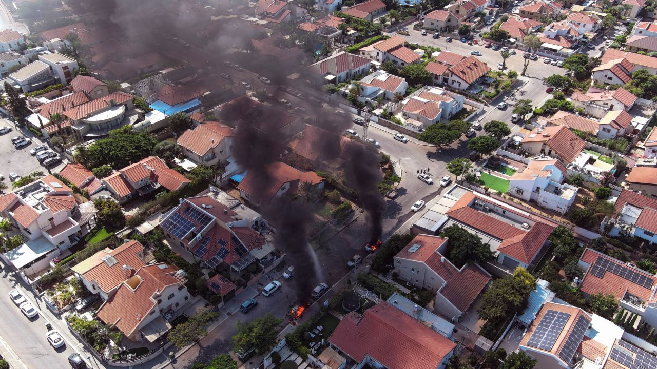 An aerial view shows vehicles on fire as rockets are launched from Gaza, in Ashkelon, southern Israel October 7, 2023. REUTERS/Ilan Rosenberg