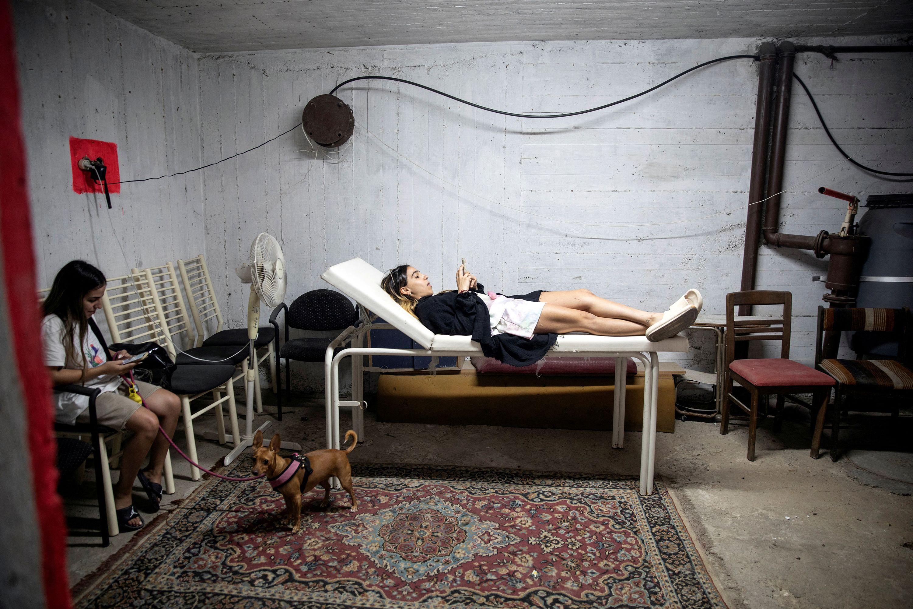People take cover in a bomb shelter in Rishon Lezion, Israel, as rockets are launched from Gaza on October 7.