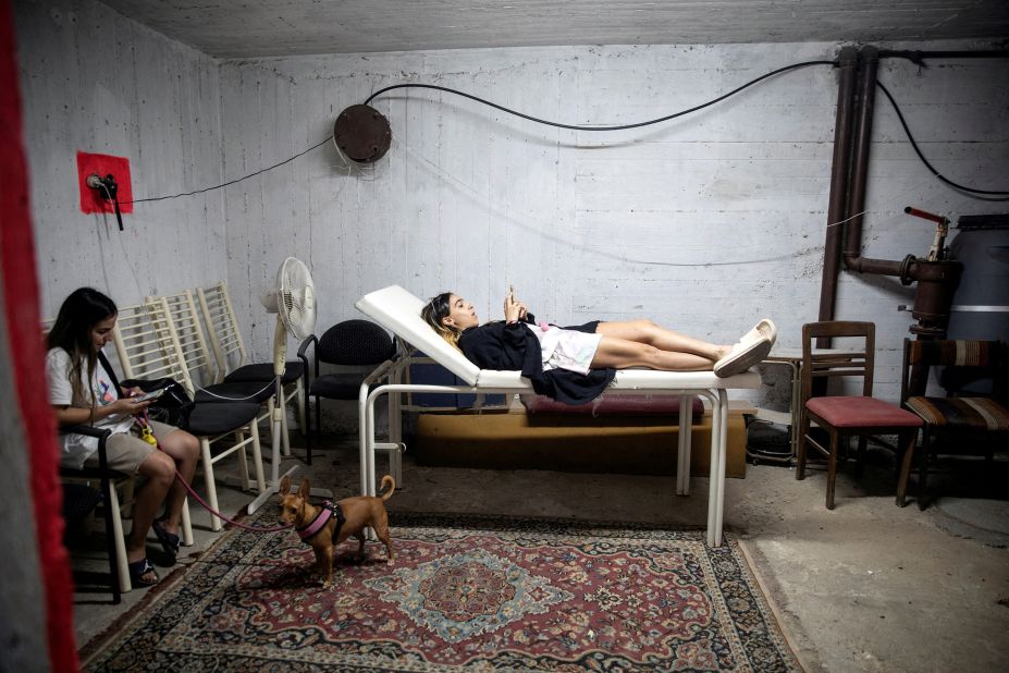 People take cover in a bomb shelter in Rishon Lezion, Israel, as rockets are launched from Gaza on Saturday.