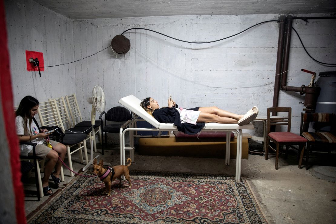 Israelis take cover in a bomb shelter as rockets are launched from the Gaza Strip.