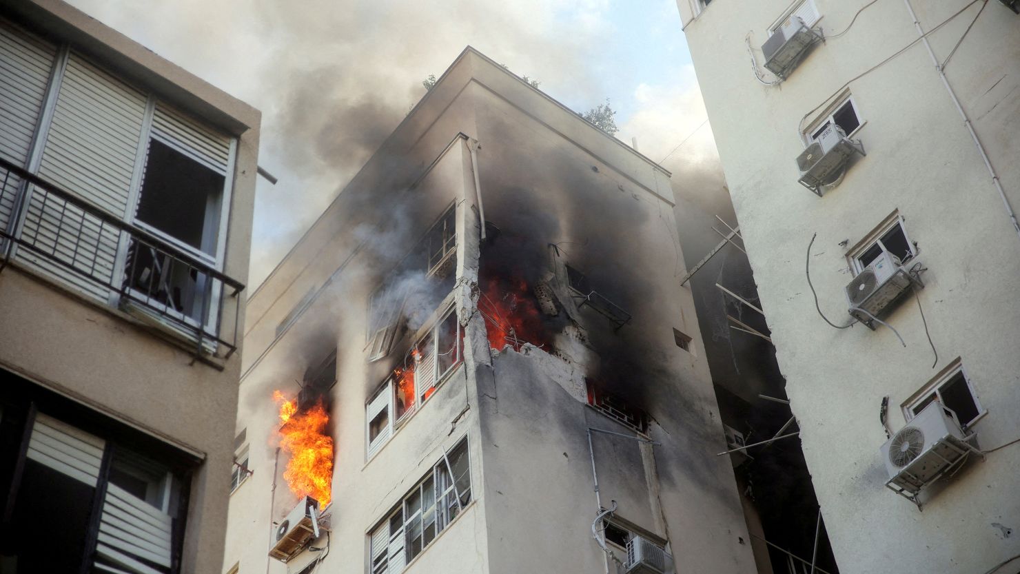 A building is ablaze following rocket attacks in Tel Aviv, Israel, on October 7, 2023.