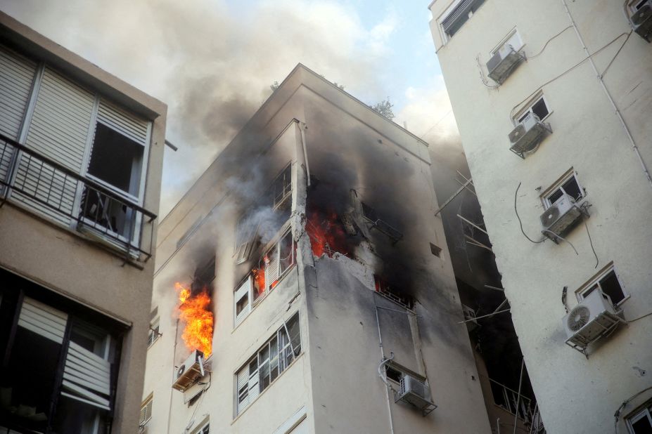 A building in Tel Aviv is ablaze Saturday, October 7, following rocket attacks from Gaza.