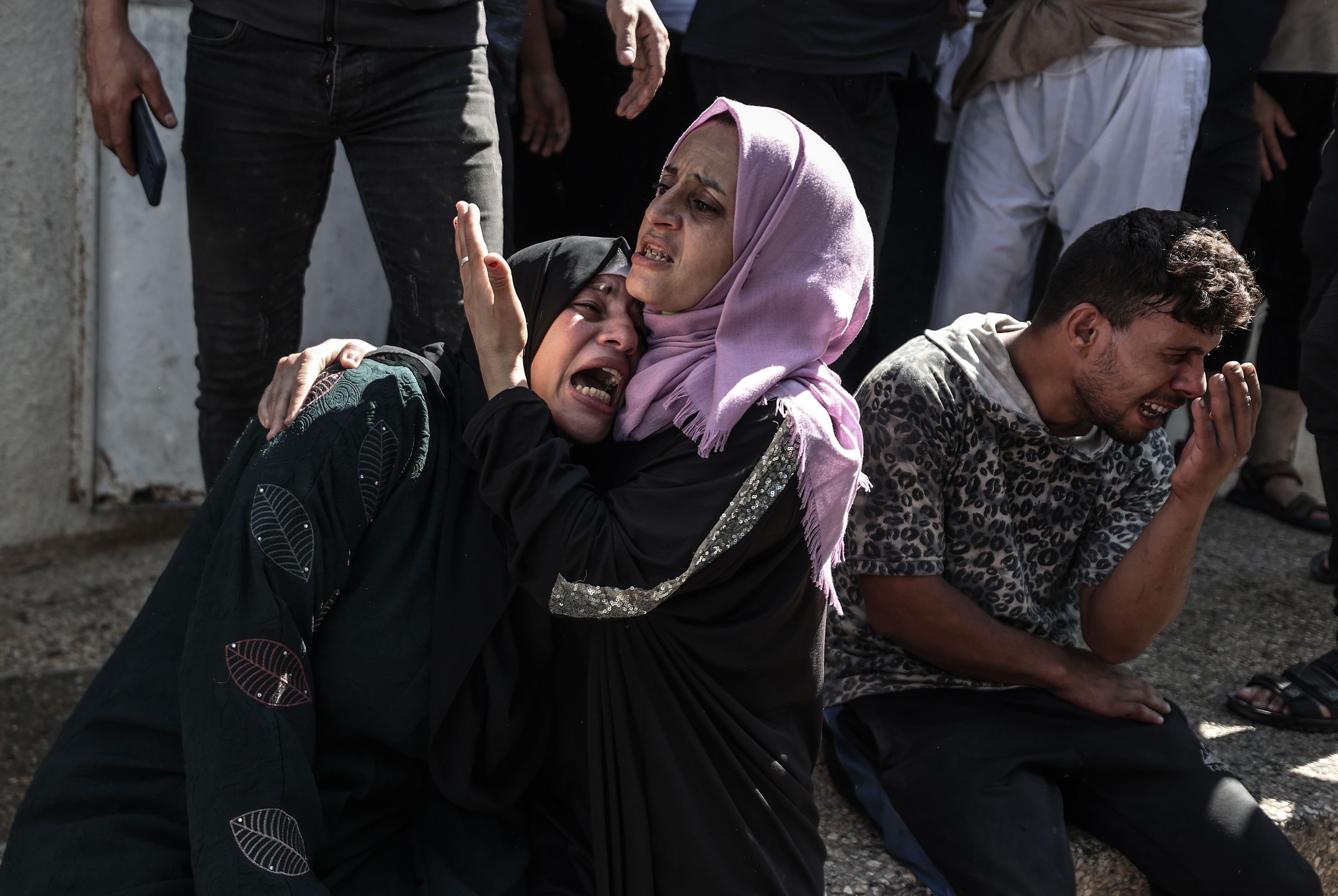 Relatives of Palestinians killed on Saturday, October 7, mourn at the morgue of a hospital in Gaza.
