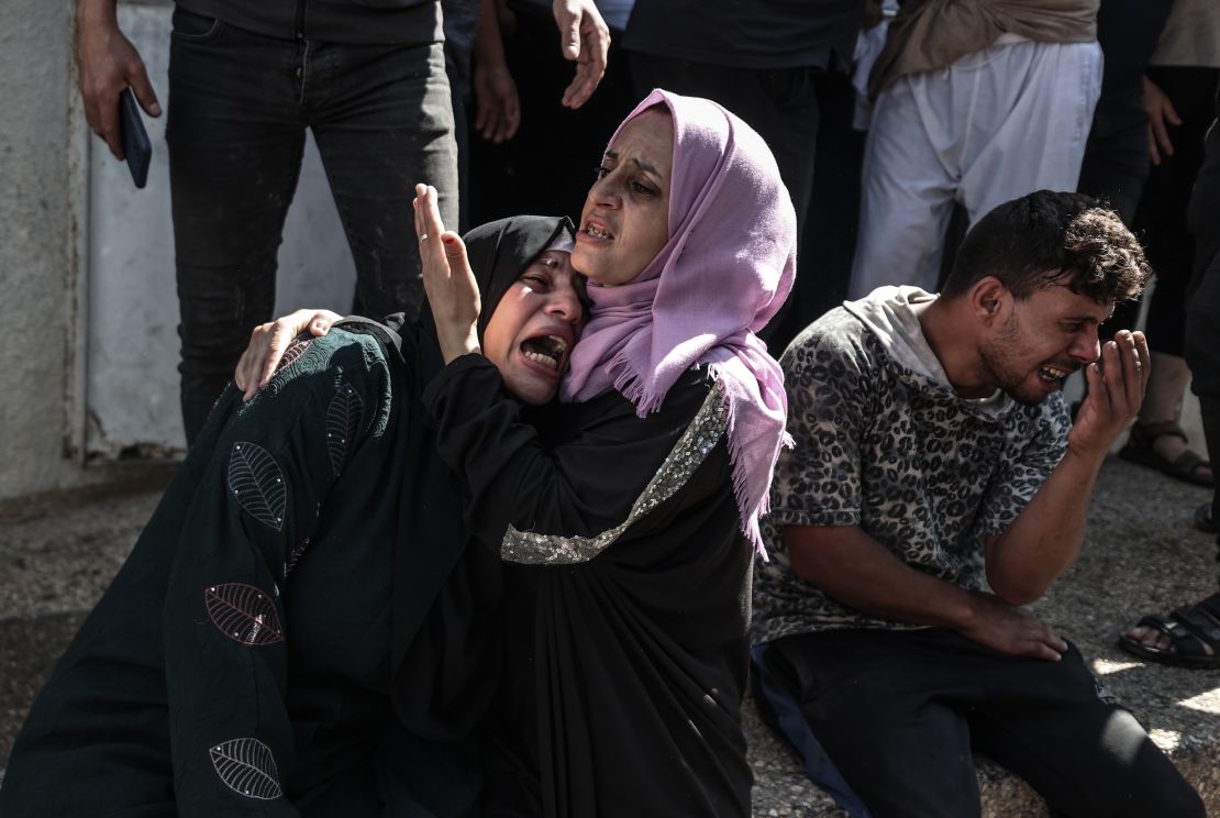  Relatives of Palestinians, killed by Israeli forces during airstrike clashes, mourn after they were taken to the morgue of Shifa Hospital in Gaza City.