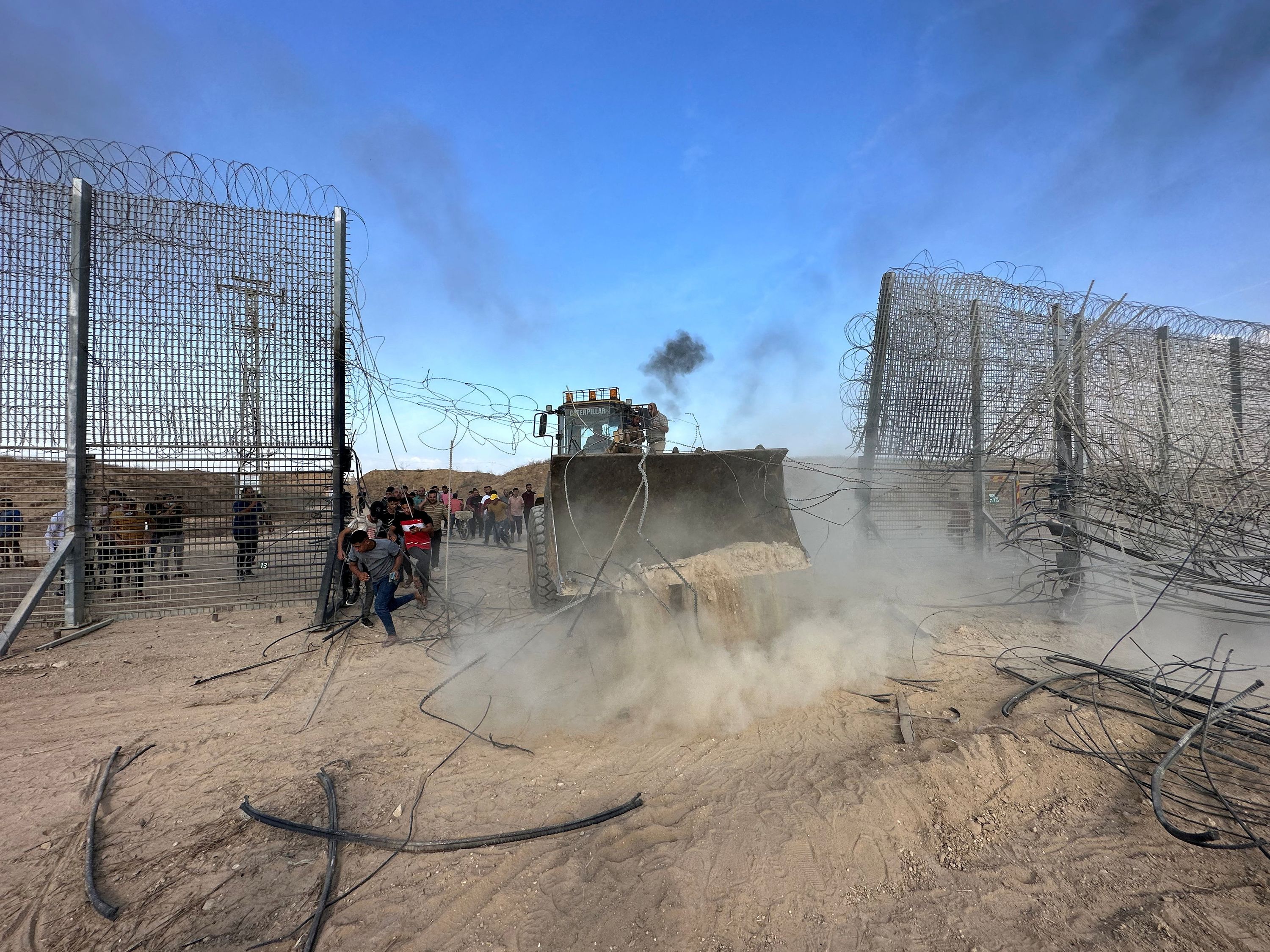 Palestinians break into the Israeli side of the Israel-Gaza border, after gunmen infiltrated parts of southern Israel on October 7.
