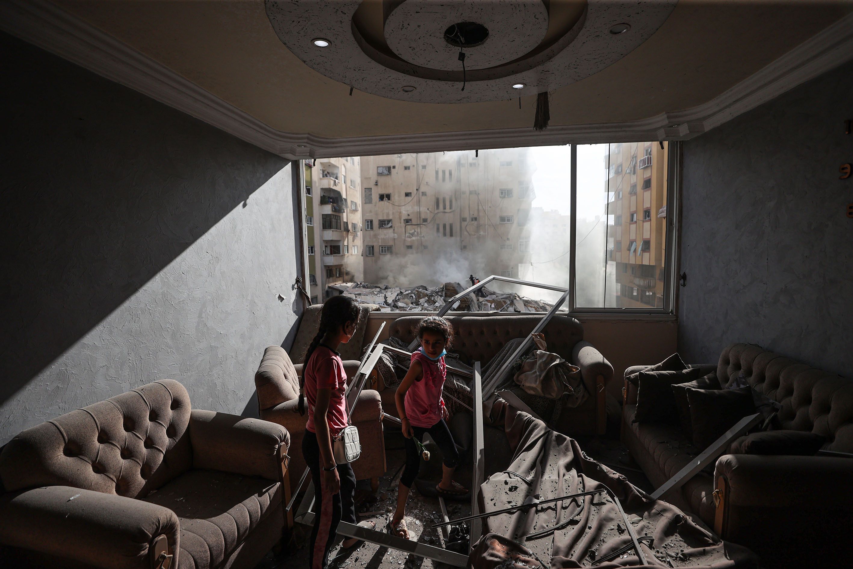 Children are seen in a damaged house in Gaza after Israeli airstrikes on October 7.