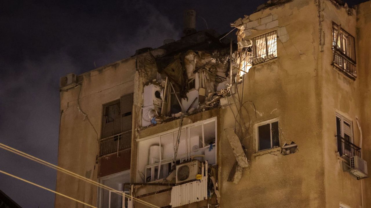 A building in Tel Aviv is damaged by a rocket fired by Palestinian militants from Gaza on October 7, 2023.