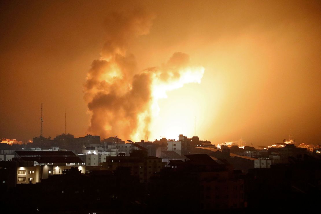 Fire and smoke rises above buildings during an Israeli air strike in Gaza City on October 8, 2023.