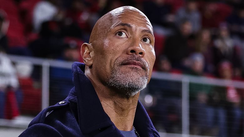 WASHINGTON, DC - FEBRUARY 19: XFL owner Dwayne Johnson looks on from the sideline during the first half of the XFL game between the DC Defenders and the Seattle Sea Dragons at Audi Field on February 19, 2023 in Washington, DC. (Photo by Scott Taetsch/Getty Images)