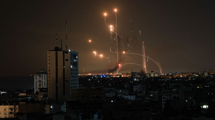 TOPSHOT - An Israeli missile launched from the Iron Dome defence missile system attempts to intercept a rocket, fired from the Gaza Strip, over the city of Netivot in southern Israel on October 8, 2023. Israel, reeling from the deadliest attack on its territory in half a century, formally declared war on Hamas Sunday as the conflict's death toll surged close to 1,000 after the Palestinian militant group launched a massive surprise assault from Gaza. (Photo by MAHMUD HAMS / AFP) (Photo by MAHMUD HAMS/AFP via Getty Images)