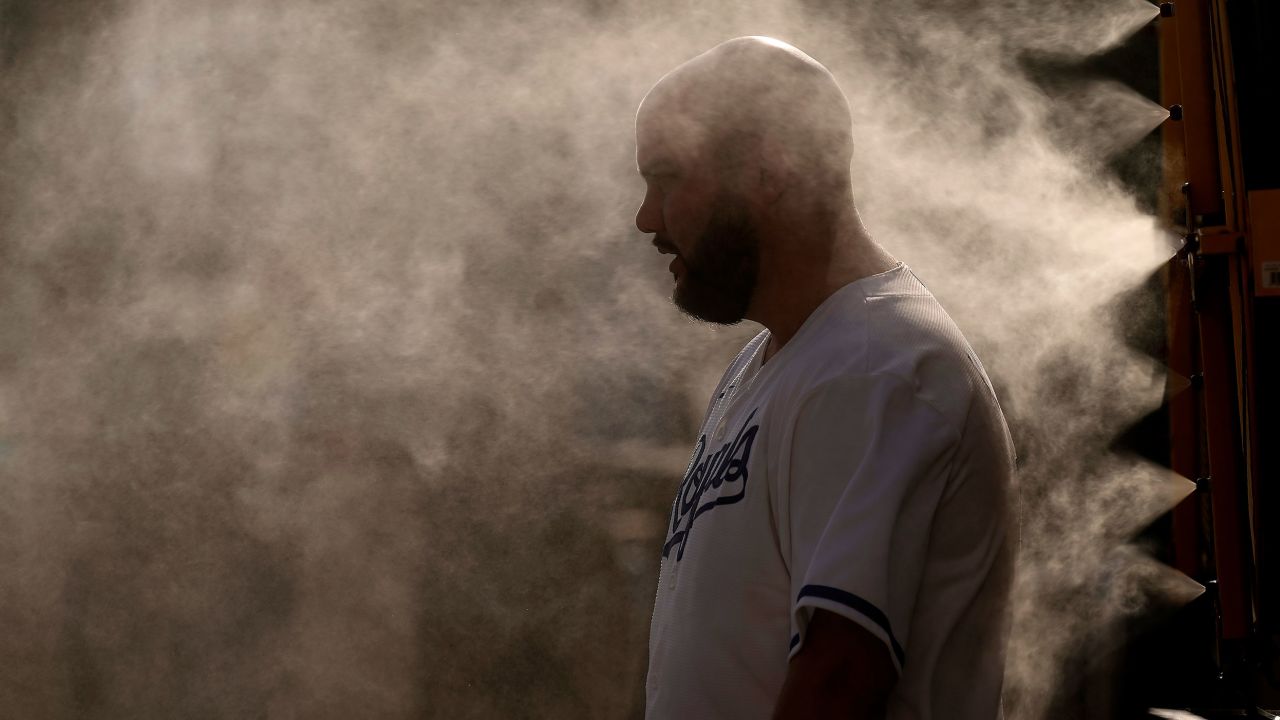A man cools off in a mister at Kauffman Stadium as temperatures approach 100 degrees fahrenheit before a baseball game between the Kansas City Royals and the Cleveland Guardians on June 28, 2023, in Kansas City, Missouri. 