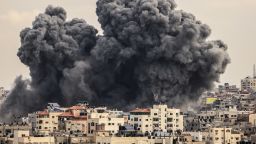 A plume of smoke rises in the sky over Gaza City during an Israeli airstrike on Monday.