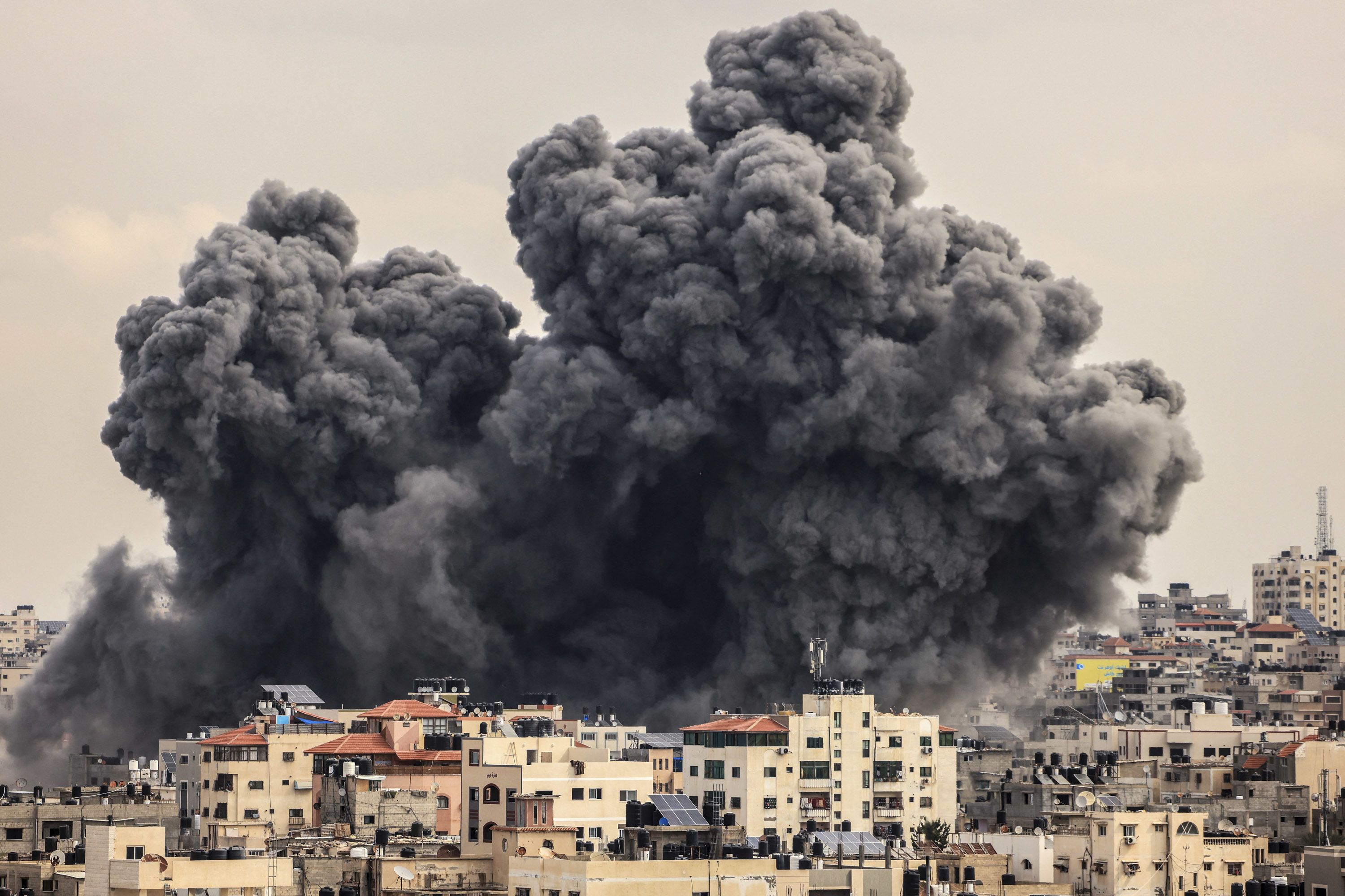 A plume of smoke rises in the sky over Gaza City during an Israeli airstrike on October 9.