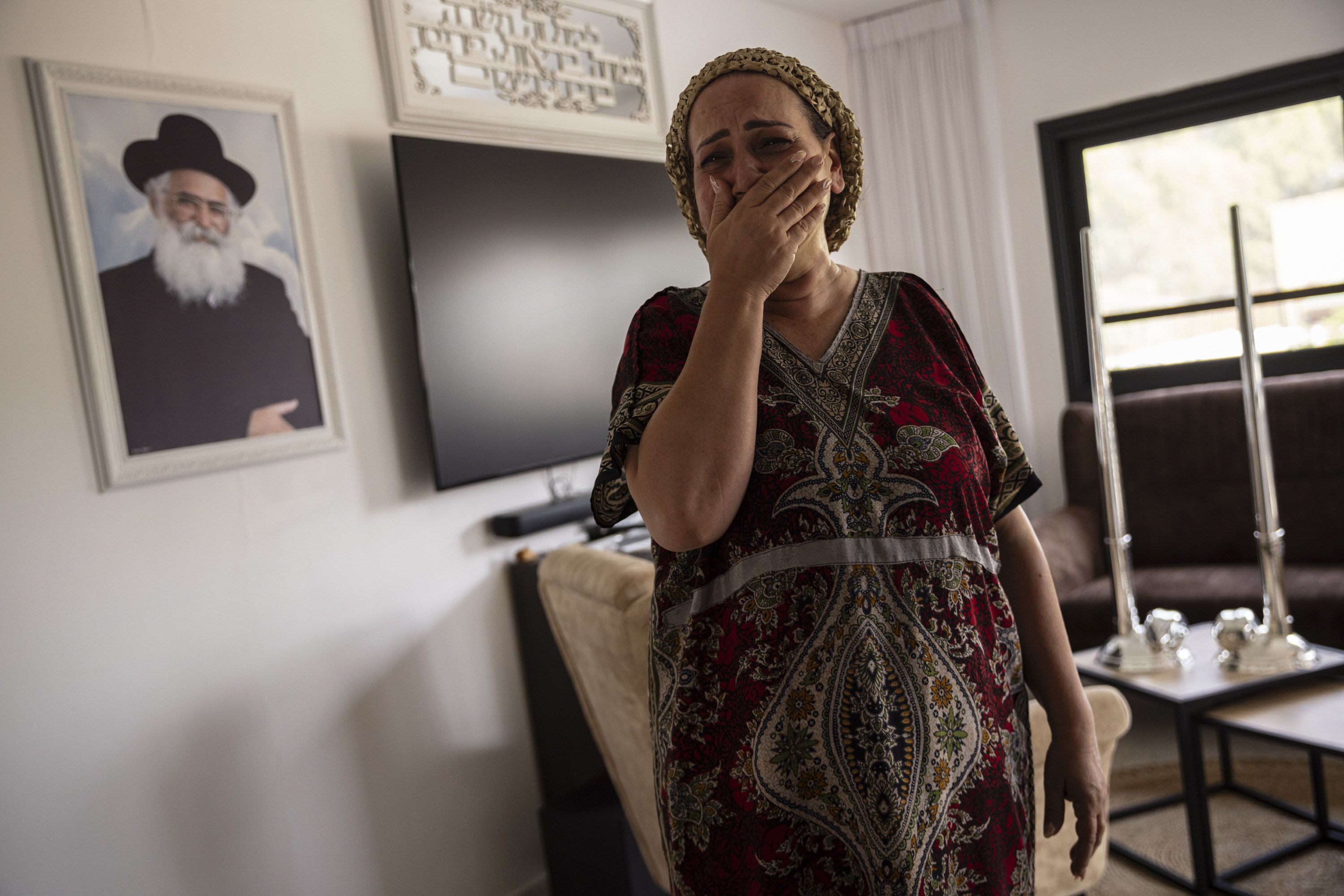 Tali Touito reacts as she describes how Hamas gunmen attacked and took over the police station on her street, in Sderot, Israel, on Sunday, October 8.