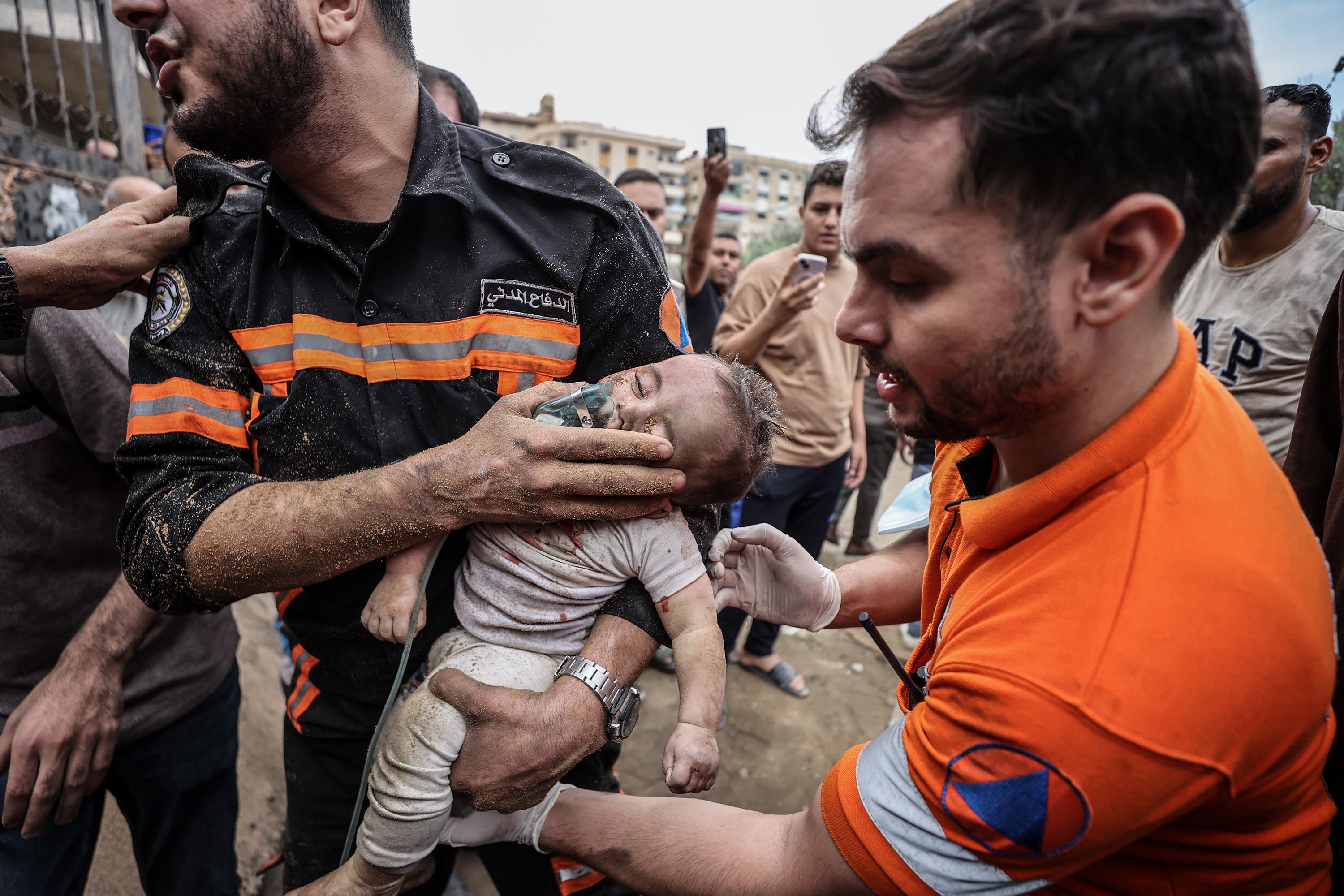 Six-month-old Sama Alwadia is rescued from the rubble in Gaza City on October 9. Though the child had survived the initial strike, she died later while being treated for her injuries.