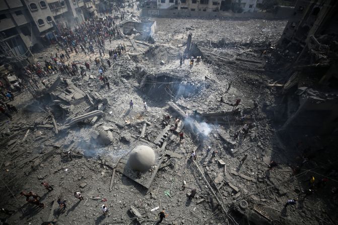 Palestinians inspect the damage following an Israeli airstrike on the Sousi mosque in Gaza City on October 9.