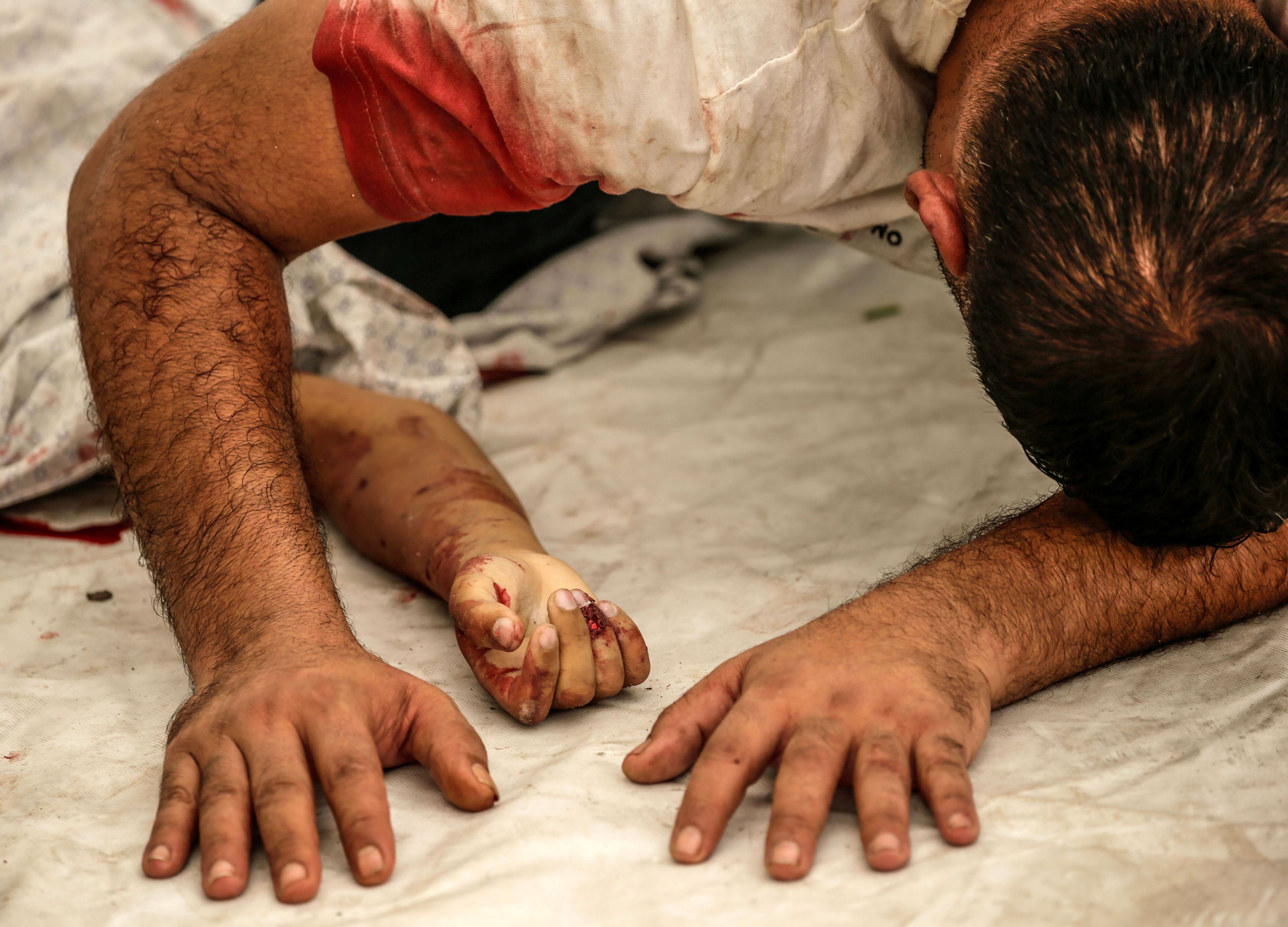 A Palestinian man mourns over the body of his nephew killed in an Israeli airstrike in Gaza City on October 9.
