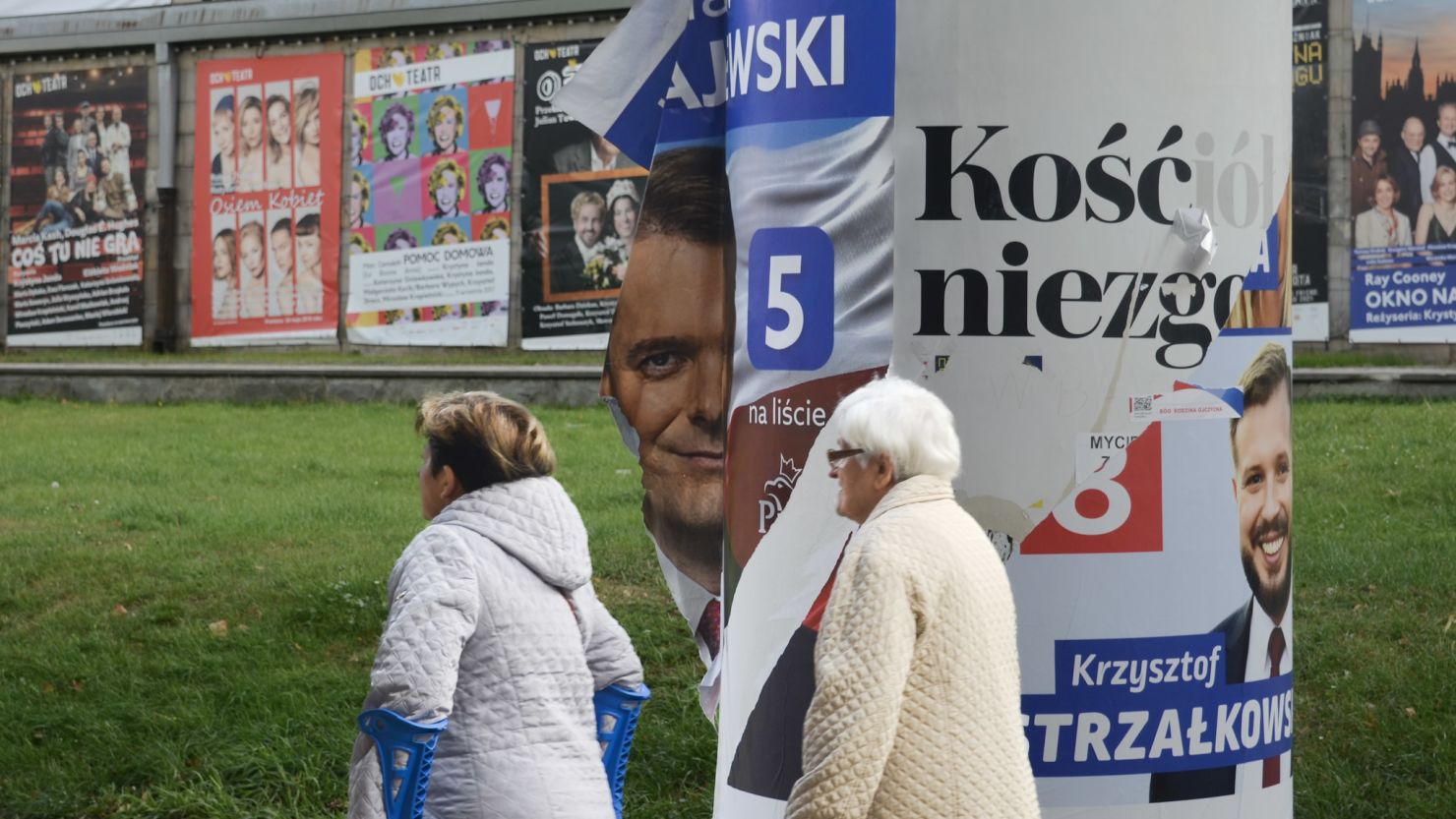 A defaced poster for a PiS candidate billows in the wind in Warsaw. Poland's election campaign has been toxic, with polls indicating a tight result.