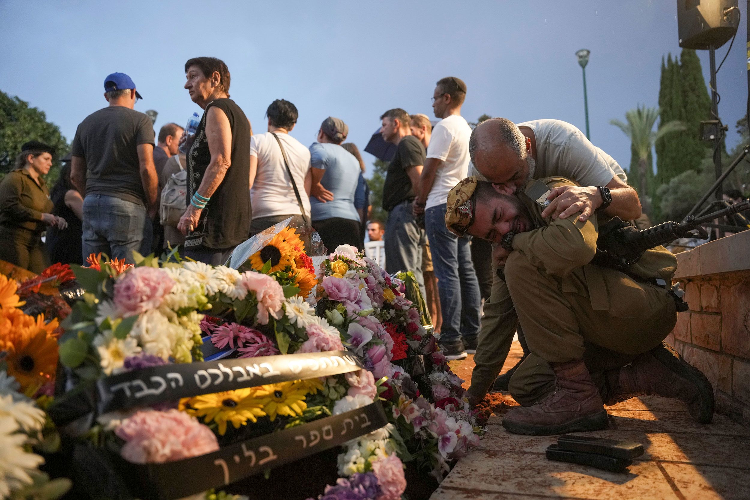 Friends and relatives of Ilai Bar Sade mourn next to his grave during his funeral at a military cemetery in Tel Aviv, Israel, on October 9.