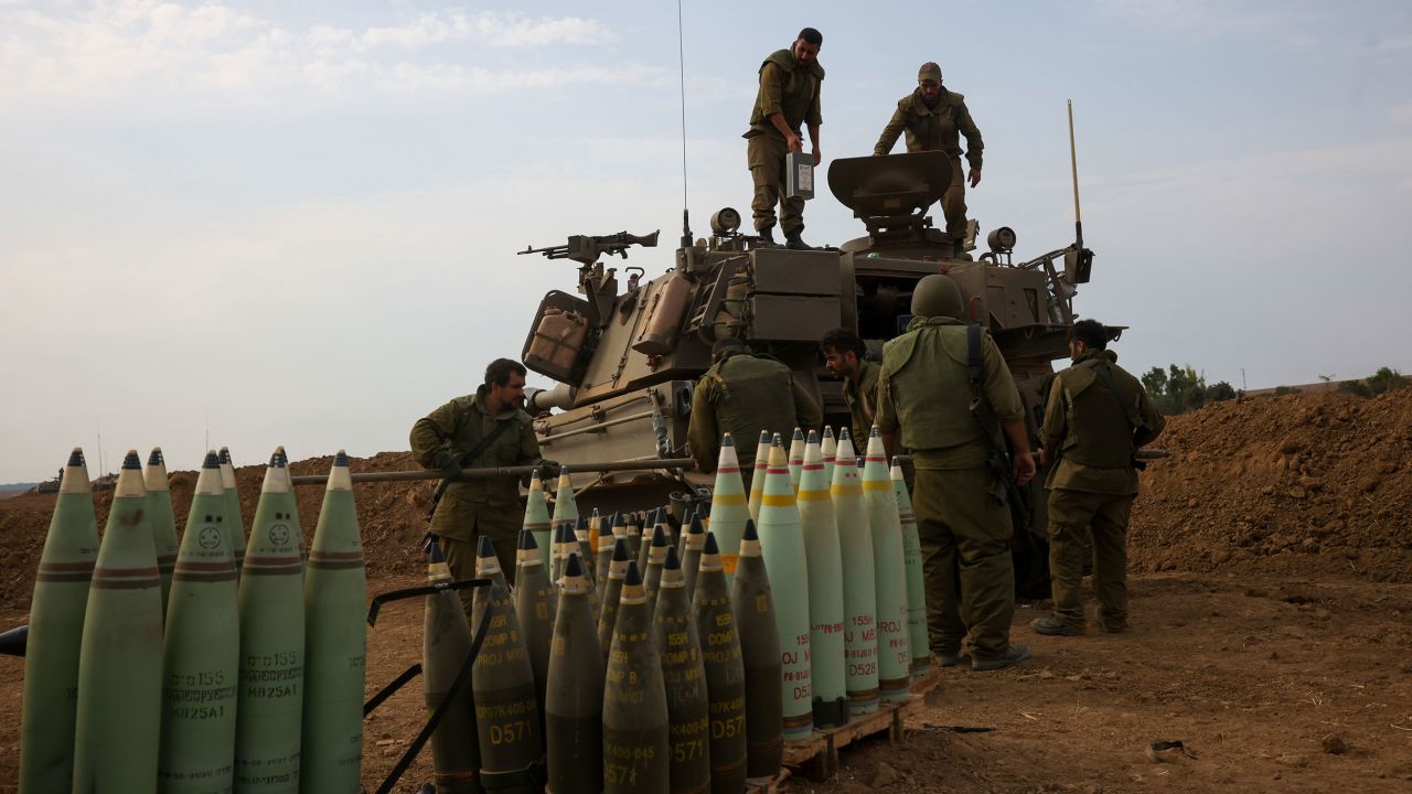 Israeli soldiers take position near the border between Gaza and Israel on October 9.