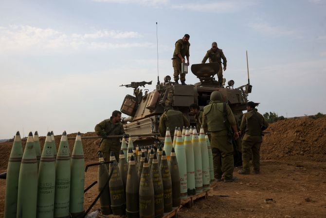 Israeli soldiers take position near the border between Gaza and Israel on October 9.