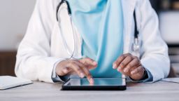 Shot of a female doctor using her digital tablet - stock photo