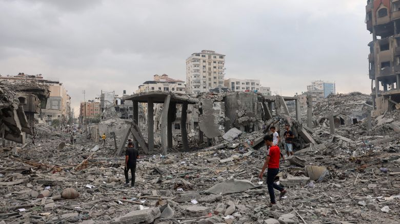 TOPSHOT - Palestinians inspect the destruction from Israeli airstrikes in Gaza City's al-Rimal neighbourhood early on October 10, 2023. Israel kept up its deadly bombardment of Hamas-controlled Gaza on October 10 after the Palestinian militant group threatened to execute some of the around 150 hostages it abducted in a weekend assault if air strikes continue without warning. (Photo by MOHAMMED ABED / AFP) (Photo by MOHAMMED ABED/AFP via Getty Images)
